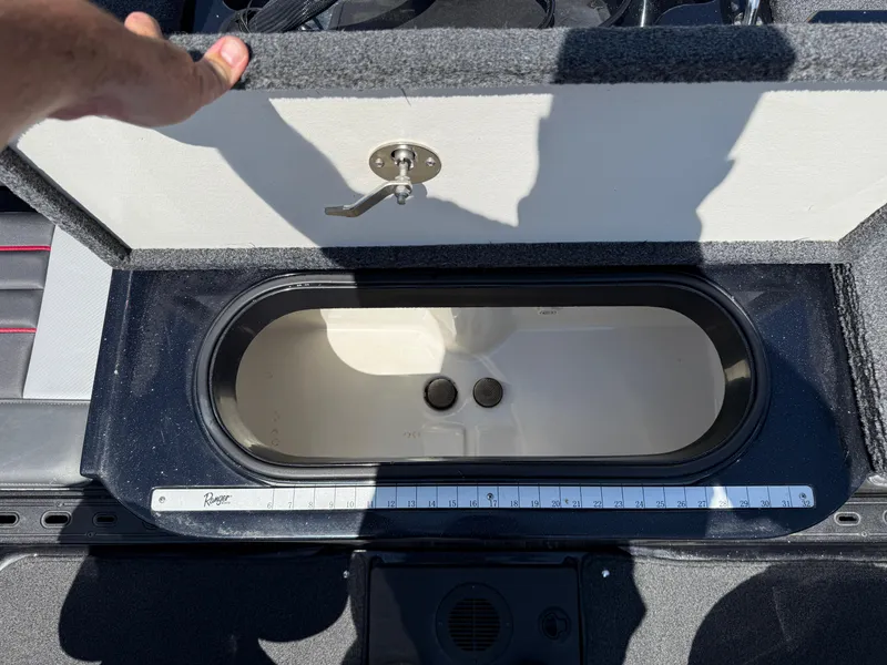 Slide: The Image of Open storage compartment in 2022 Ranger 1880MS boat with measuring ruler. - 31