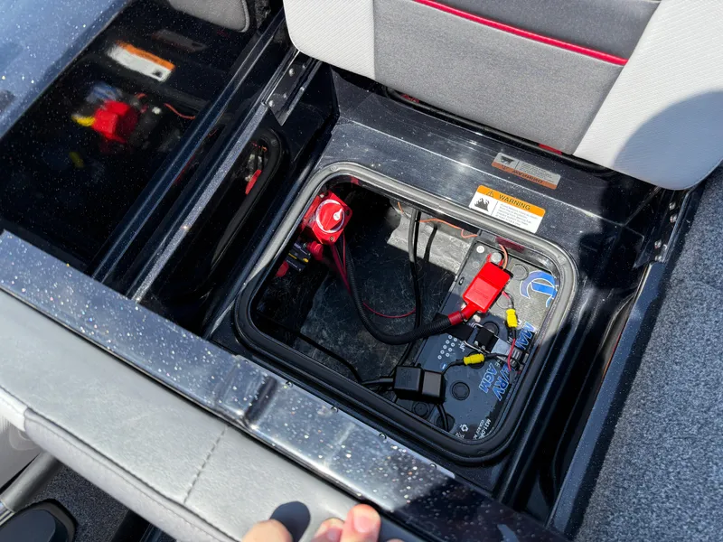 Slide: The Image of 2022 Ranger 1880MS boat battery compartment with wiring and safety labels. - 32