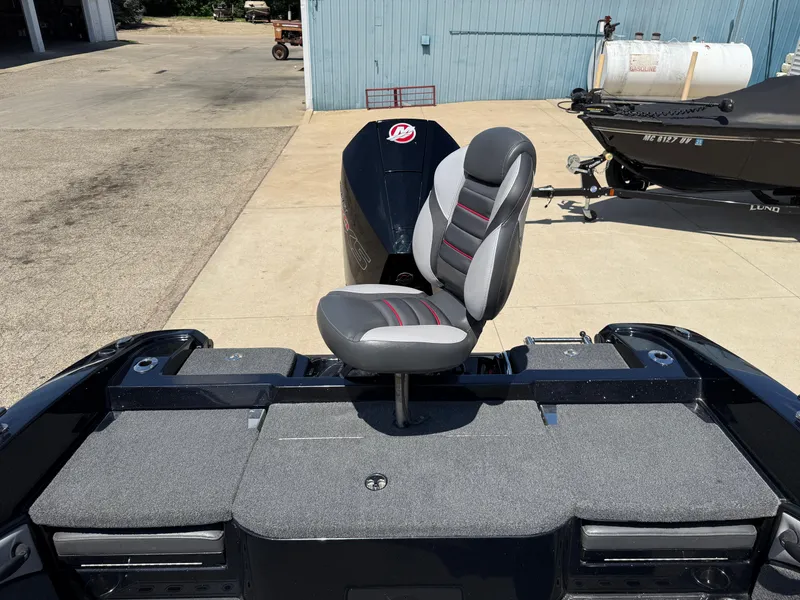 Slide: The Image of 2022 Ranger 1880MS boat with a cushioned seat on a sunny day. - 33