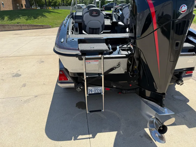 Slide: The Image of 2022 Ranger 1880MS boat with outboard motor and ladder, parked on concrete. - 35