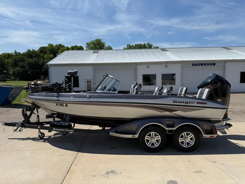 Slide: The Image of 2022 Ranger 1880MS boat on trailer outside showroom, sunny day. - 4
