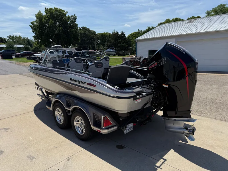 Slide: The Image of 2022 Ranger 1880MS boat on trailer, parked outdoors, featuring a powerful outboard motor. - 5
