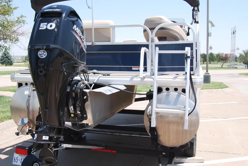 Slide: The Image of 2022 Sun Tracker Bass Buggy 16 XL pontoon boat with Mercury 50 engine, parked on trailer. - 4