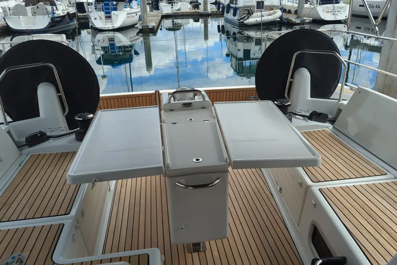 Slide: The Image of Cockpit of 2021 Jeanneau Sun Odyssey 440 yacht with teak flooring and foldable table. - 12