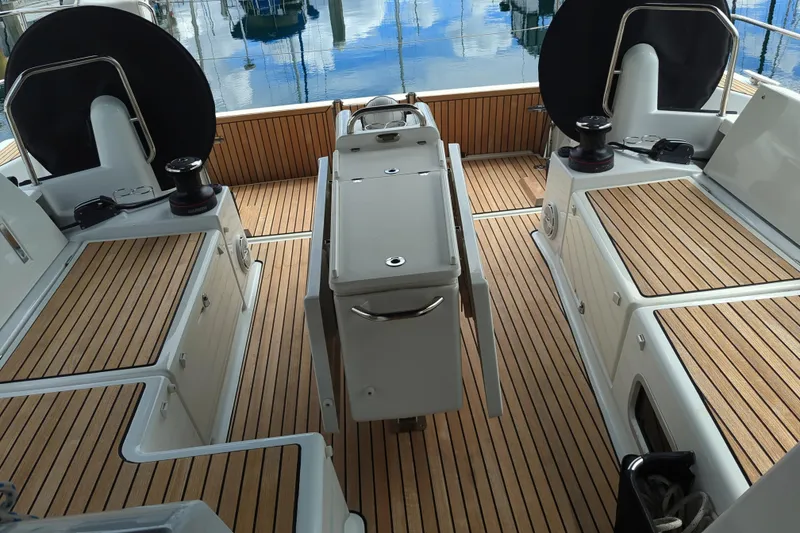 Slide: The Image of Cockpit of 2021 Jeanneau Sun Odyssey 440 with teak flooring and dual helm stations. - 13