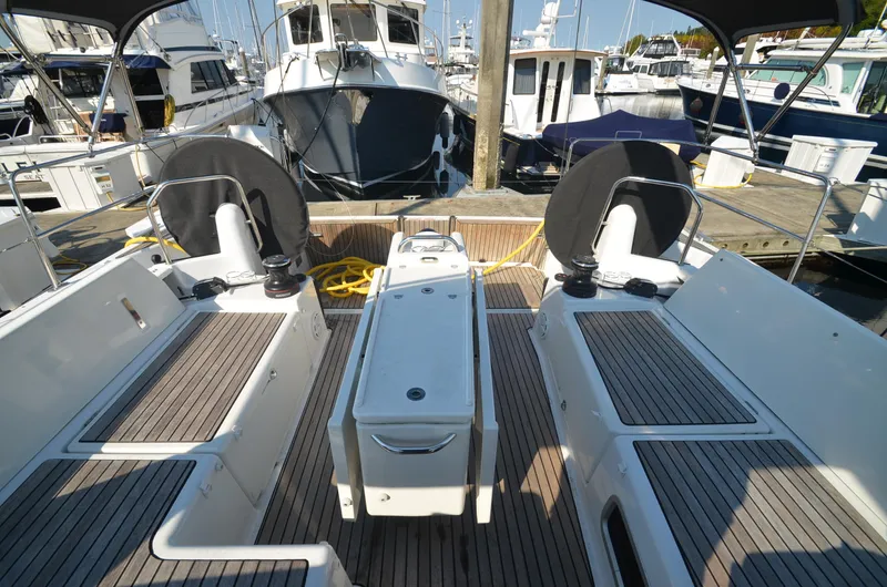 Slide: The Image of Cockpit of 2021 Jeanneau Sun Odyssey 440 yacht at marina, featuring dual steering wheels. - 20