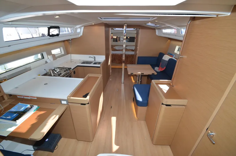 Slide: The Image of Interior of 2021 Jeanneau Sun Odyssey 440 yacht, featuring modern kitchen and seating area. - 21