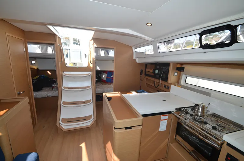 Slide: The Image of Interior of 2021 Jeanneau Sun Odyssey 440 sailboat, featuring modern kitchen and cozy cabin space. - 22
