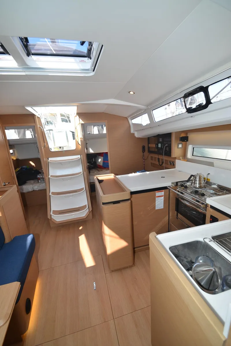 Slide: The Image of Interior of 2021 Jeanneau Sun Odyssey 440 sailboat, featuring modern kitchen and seating area. - 23