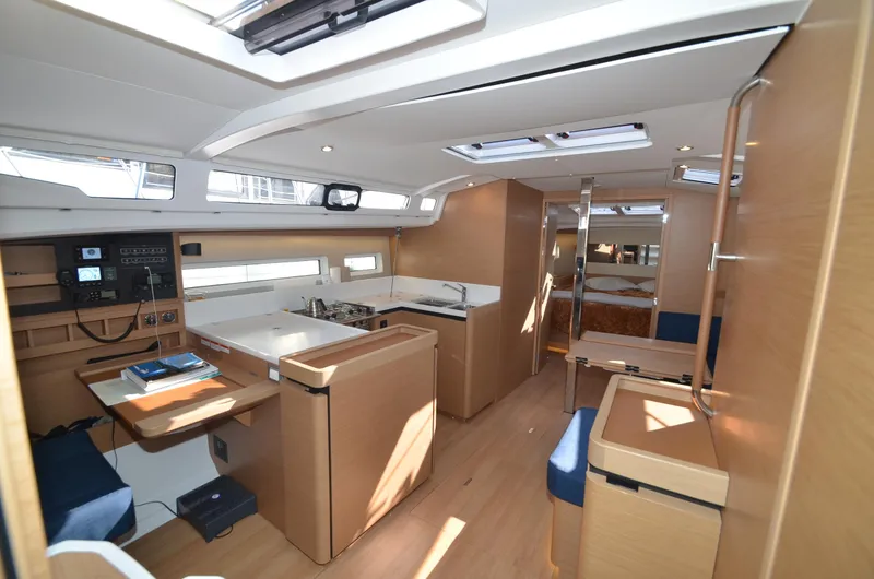 Slide: The Image of Interior of 2021 Jeanneau Sun Odyssey 440 yacht, featuring modern kitchen and navigation area. - 24