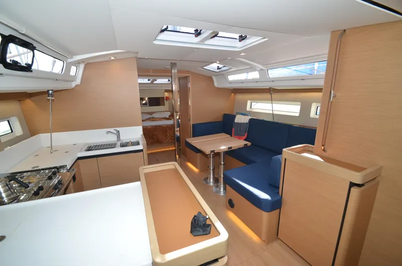Slide: The Image of Interior of 2021 Jeanneau Sun Odyssey 440 yacht with modern kitchen and seating area. - 25