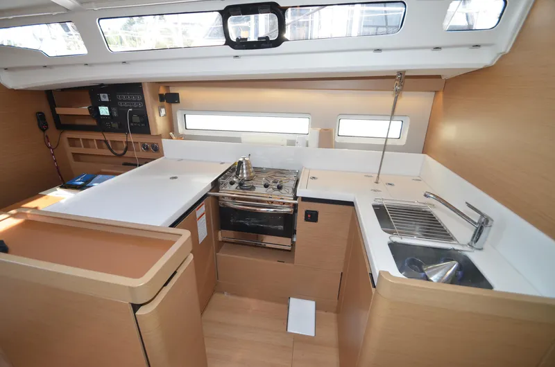 Slide: The Image of Modern kitchen interior of 2021 Jeanneau Sun Odyssey 440 yacht, featuring stove and sink. - 29