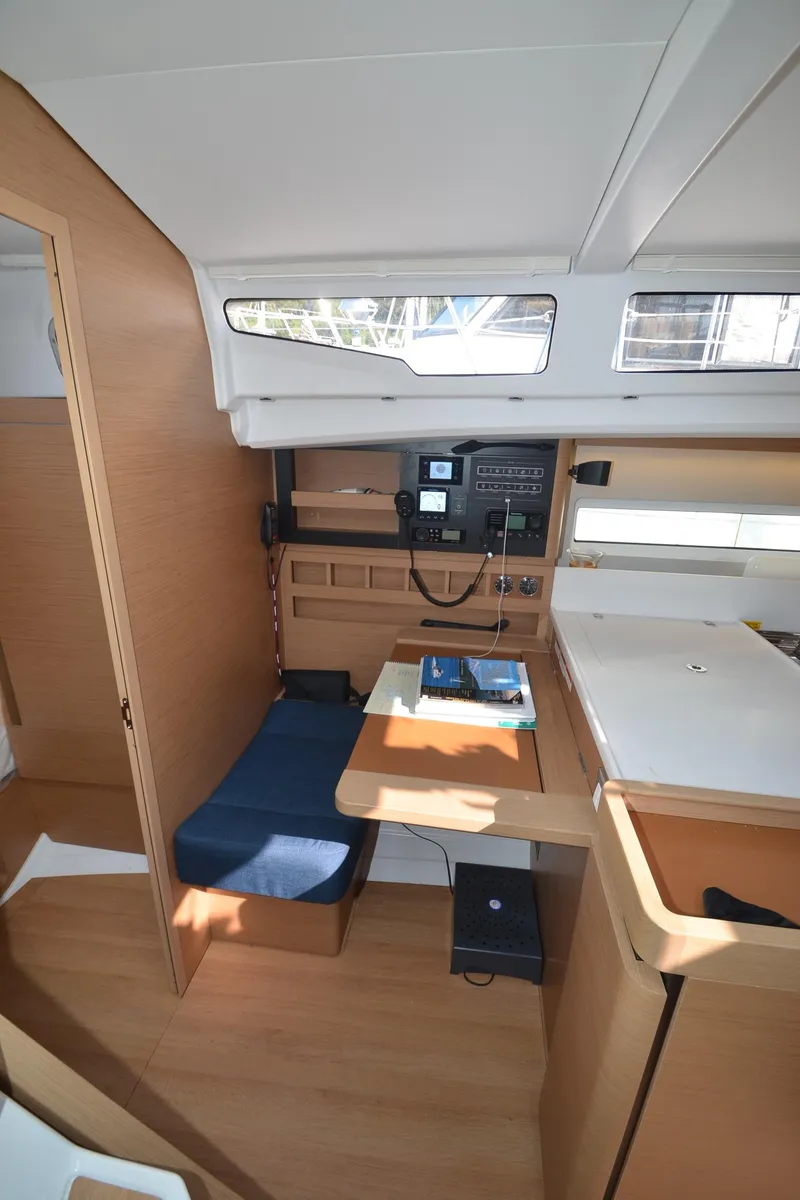 Slide: The Image of 2021 Jeanneau Sun Odyssey 440 interior with navigation station and seating area. - 30