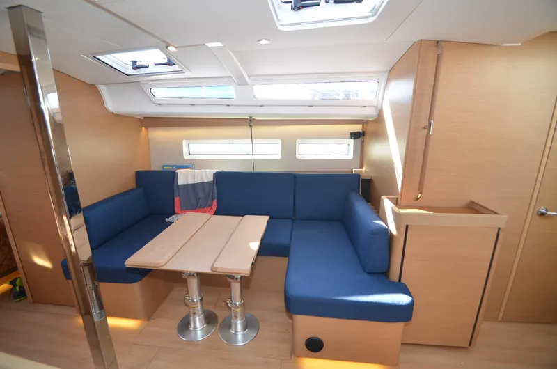 Slide: The Image of Interior of 2021 Jeanneau Sun Odyssey 440 yacht with blue seating and wooden accents. - 31