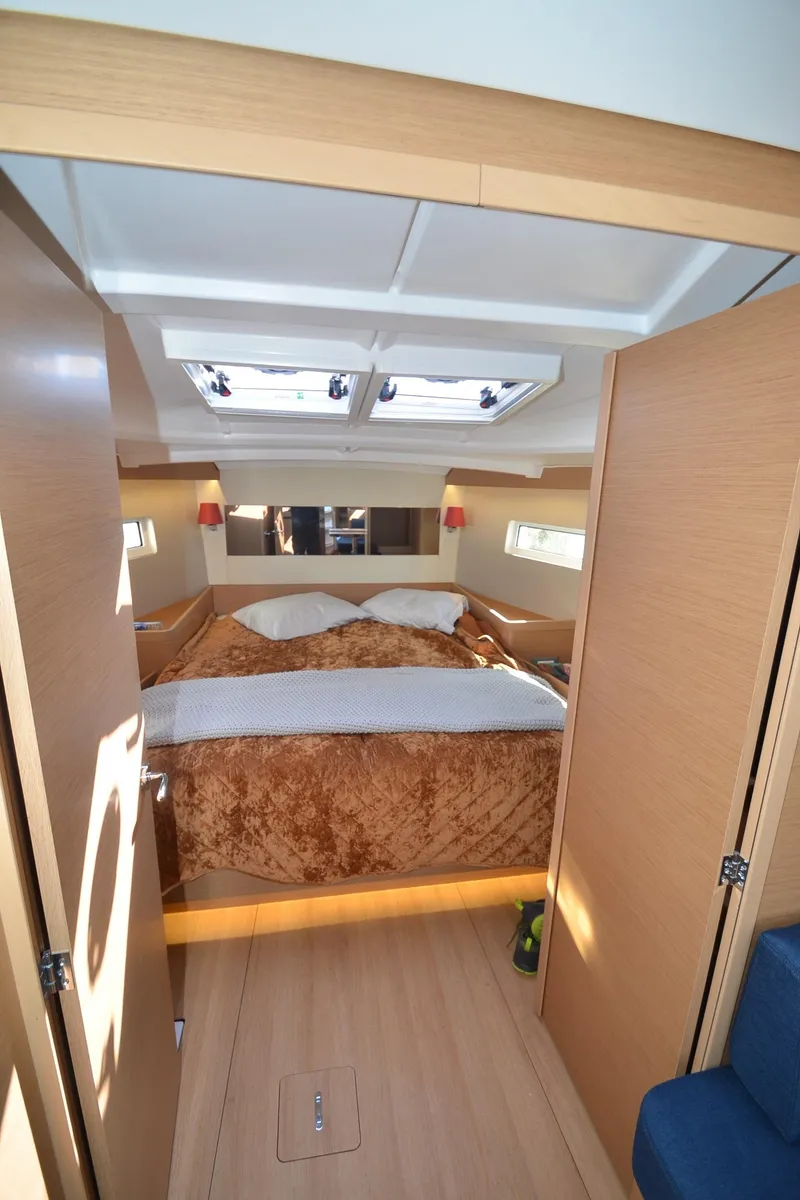 Slide: The Image of Interior cabin of 2021 Jeanneau Sun Odyssey 440 yacht with cozy bedding. - 33