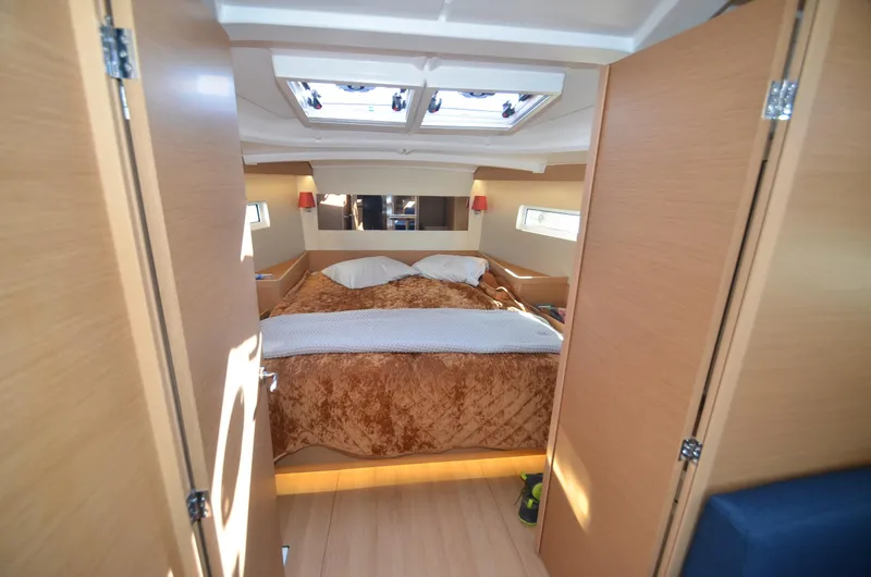 Slide: The Image of Interior cabin of 2021 Jeanneau Sun Odyssey 440 yacht, featuring a cozy bed and modern design. - 34