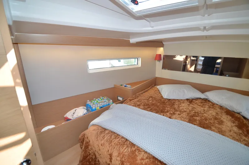 Slide: The Image of Cozy cabin interior of 2021 Jeanneau Sun Odyssey 440 sailboat with plush bedding. - 35