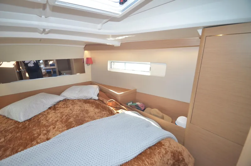 Slide: The Image of Cozy cabin interior of 2021 Jeanneau Sun Odyssey 440 yacht with plush bedding. - 36