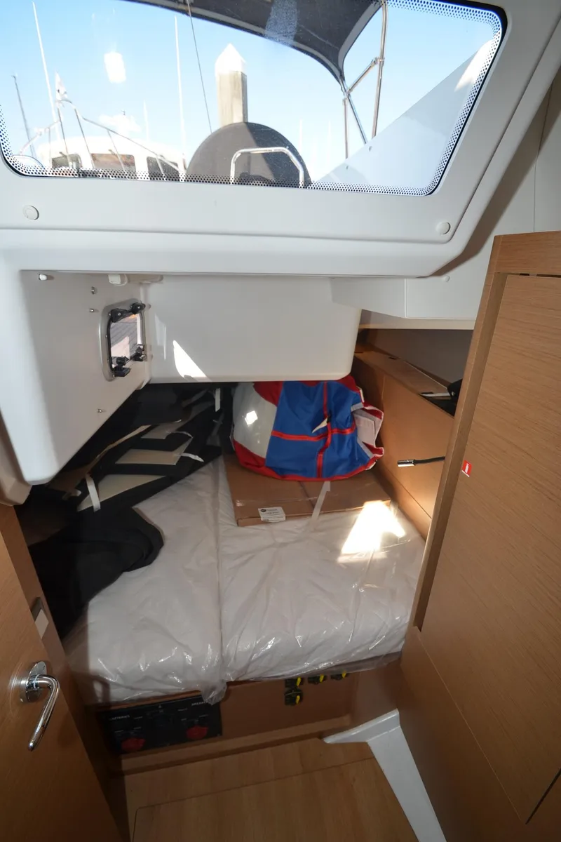 Slide: The Image of 2021 Jeanneau Sun Odyssey 440 cabin interior with bed and storage space. - 40