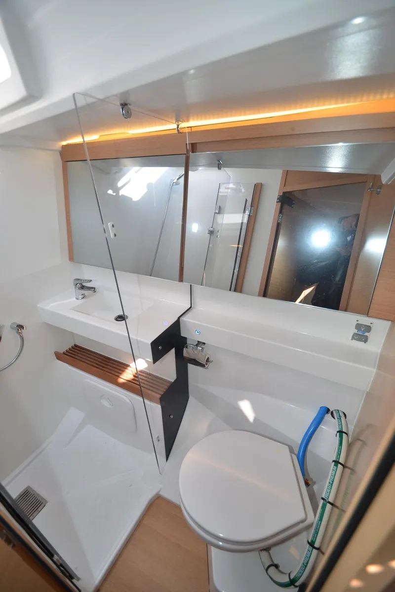 Slide: The Image of Modern bathroom in 2021 Jeanneau Sun Odyssey 440 yacht with sleek fixtures and glass shower. - 42