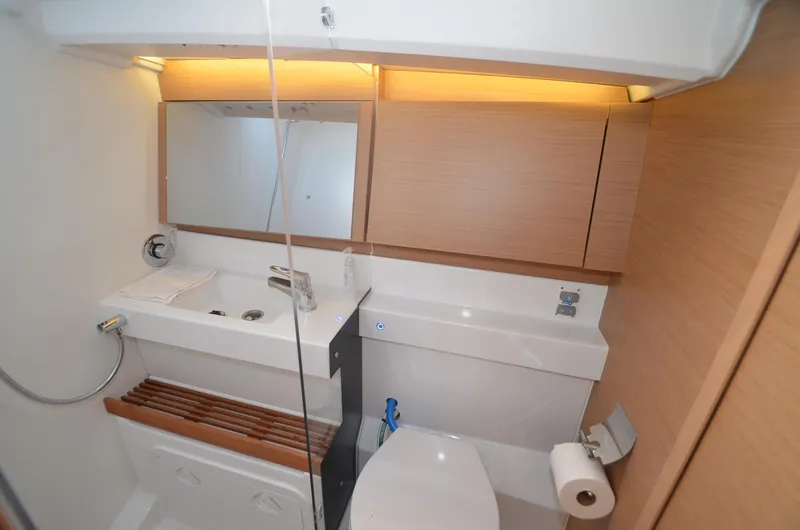 Slide: The Image of Modern bathroom in 2021 Jeanneau Sun Odyssey 440 yacht, featuring sleek design and wooden accents. - 43