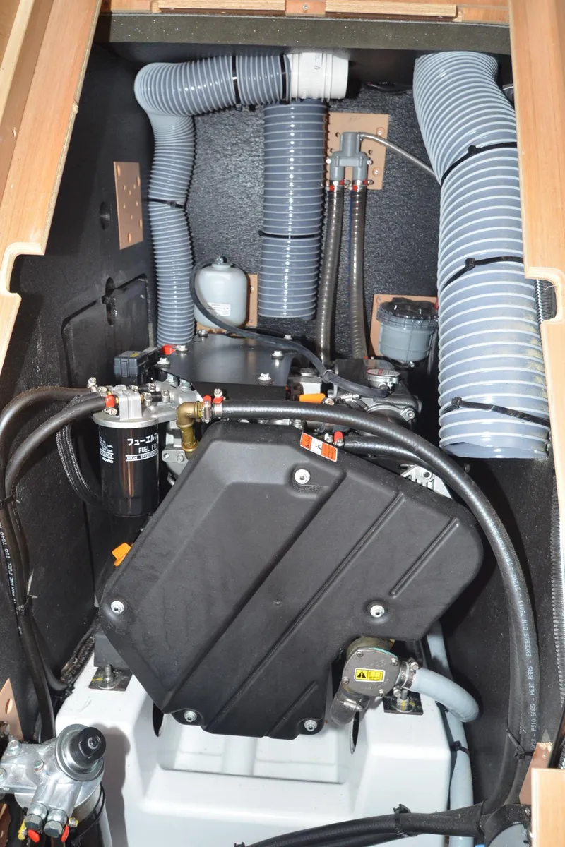 Slide: The Image of Engine compartment of 2021 Jeanneau Sun Odyssey 440 sailboat, featuring hoses and mechanical components. - 45