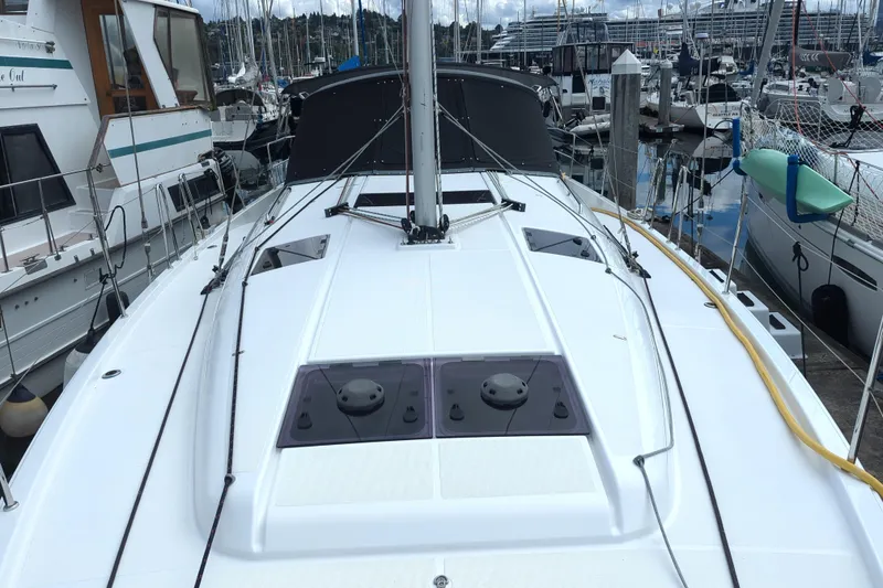 Slide: The Image of Jeanneau Sun Odyssey 440, 2021 model, docked in a marina with surrounding boats. - 6
