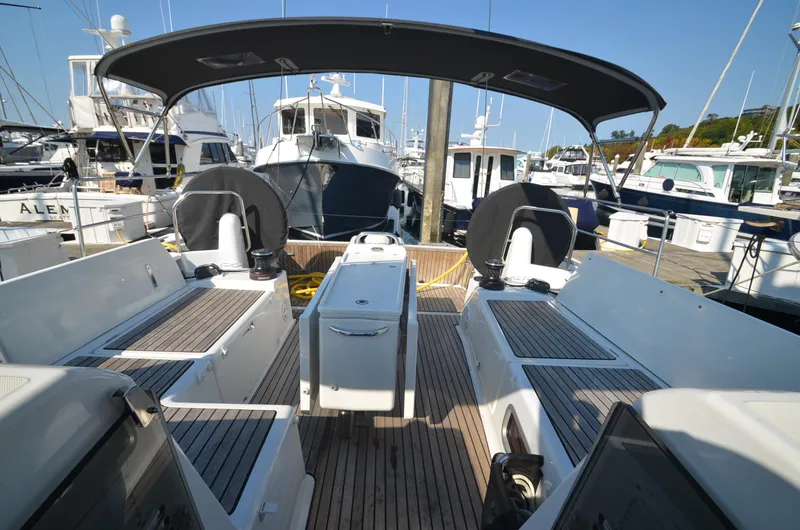 Slide: The Image of Jeanneau Sun Odyssey 440, 2021 model, docked at marina with spacious cockpit and canopy. - 9