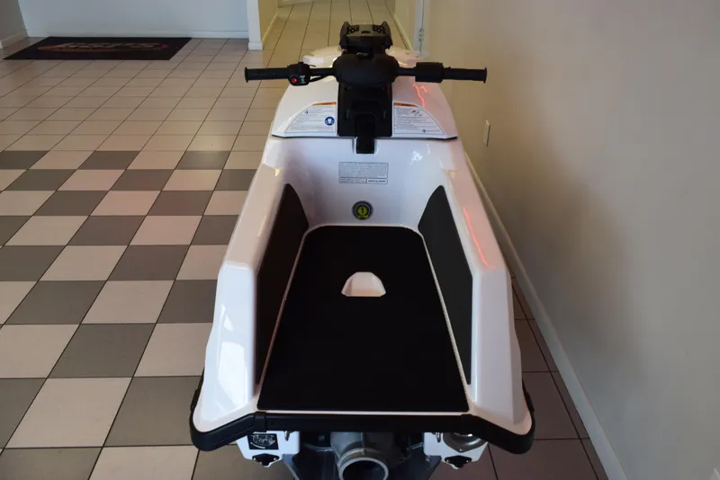 Slide: The Image of 2025 Yamaha WaveRunner SuperJet in showroom, rear view, white and black design. - 10