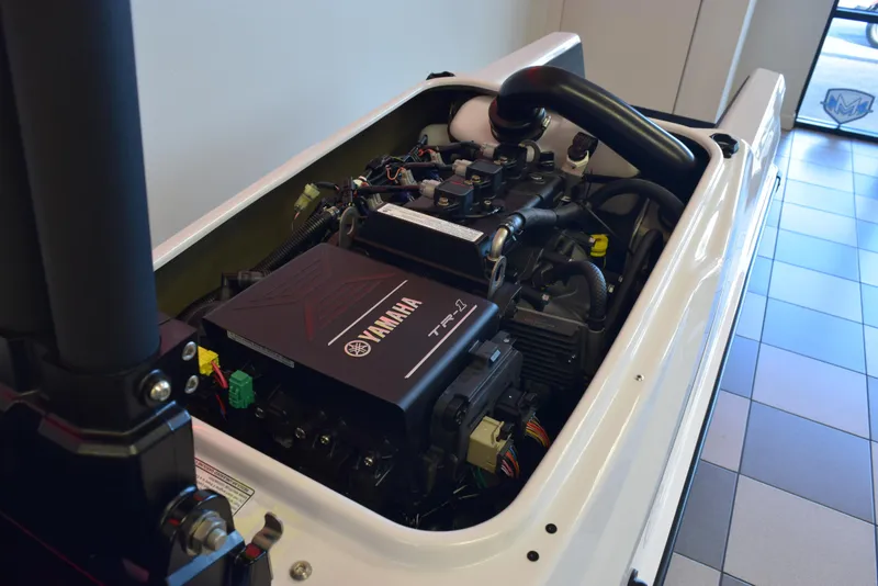 Slide: The Image of 2025 Yamaha WaveRunner SuperJet engine, detailed view in showroom setting. - 13