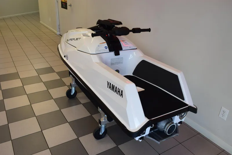 Slide: The Image of 2025 Yamaha WaveRunner SuperJet in showroom, white and black design on display stand. - 9