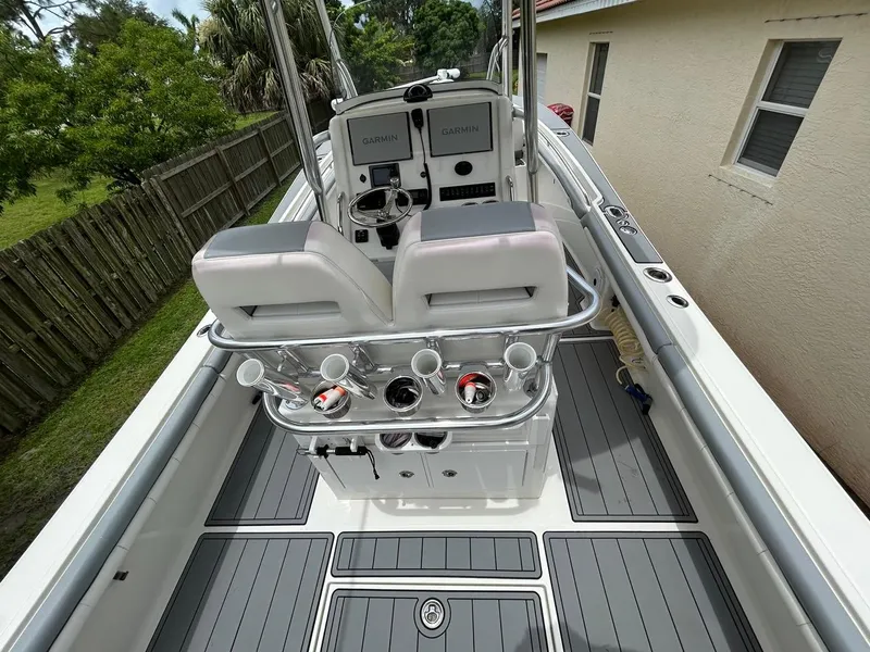 Slide: The Image of 2019 Regulator 23 boat interior with Garmin electronics and rod holders. - 11
