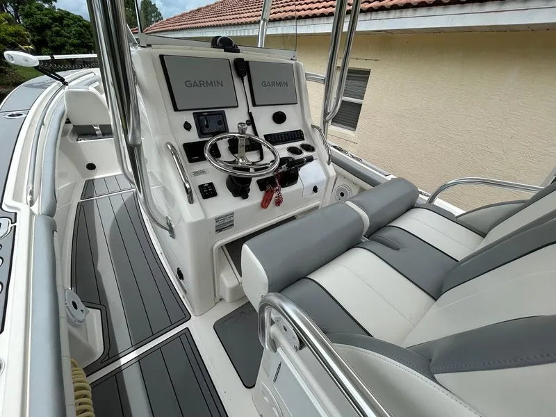 Slide: The Image of 2019 Regulator 23 boat cockpit with Garmin displays and dual seating. - 12