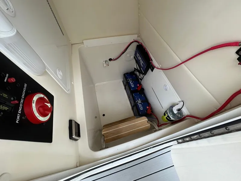 Slide: The Image of 2019 Regulator 23 boat battery compartment with wiring and control panel. - 19