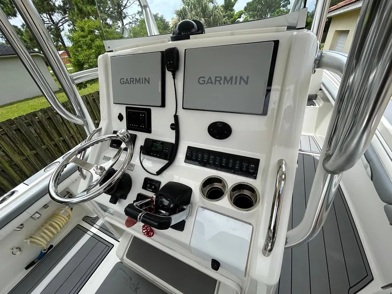 Slide: The Image of 2019 Regulator 23 boat console with dual Garmin displays and steering wheel. - 22