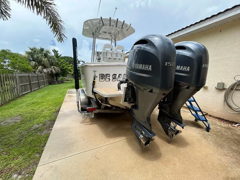 Slide: The Image of 2019 Regulator 23 boat with dual Yamaha 150 engines parked on driveway. - 29