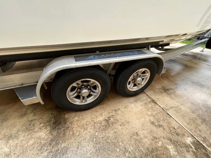 Slide: The Image of Trailer for 2019 Regulator 23 boat with dual wheels on concrete surface. - 35