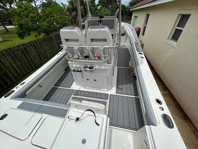Slide: The Image of 2019 Regulator 23 boat interior with seating, rod holders, and navigation equipment. - 8