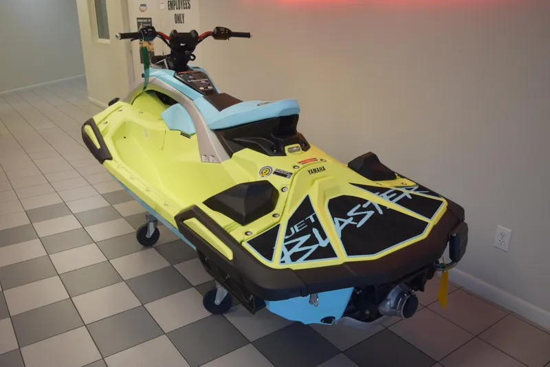 Slide: The Image of 2025 Yamaha WaveRunner JetBlaster PRO 2-Up in showroom, vibrant yellow and blue design. - 10