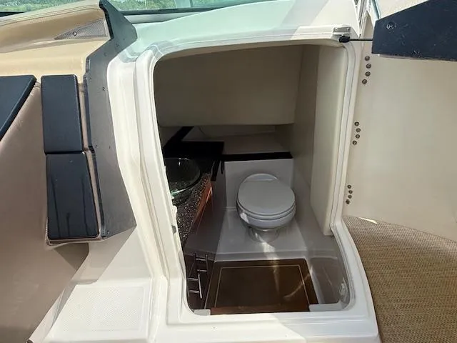 Slide: The Image of 2013 Regal 3200 Bowrider interior with compact marine toilet and sink. - 10