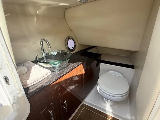 Slide: The Image of Luxurious bathroom in 2013 Regal 3200 Bowrider boat with modern sink and toilet. - 11