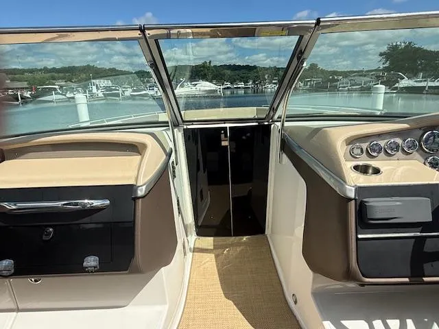 Slide: The Image of 2013 Regal 3200 Bowrider interior with dashboard and open water view. - 12