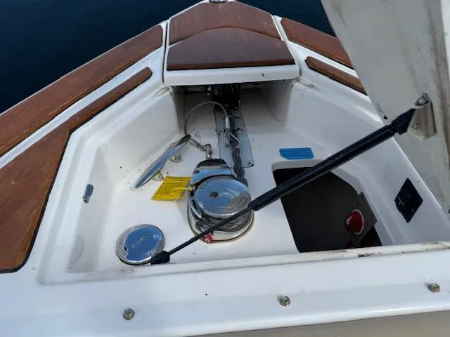 Slide: The Image of 2013 Regal 3200 Bowrider anchor compartment with open hatch and visible winch system. - 18