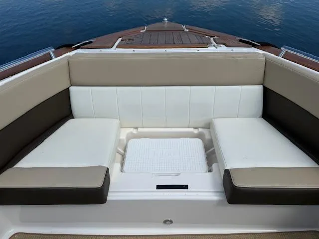 Slide: The Image of 2013 Regal 3200 Bowrider boat interior with cushioned seating and storage compartment. - 19