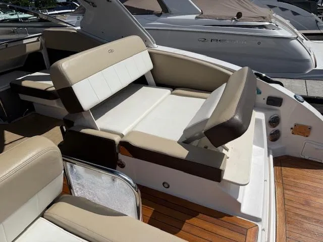 Slide: The Image of 2013 Regal 3200 Bowrider interior with beige seating and wooden deck. - 22