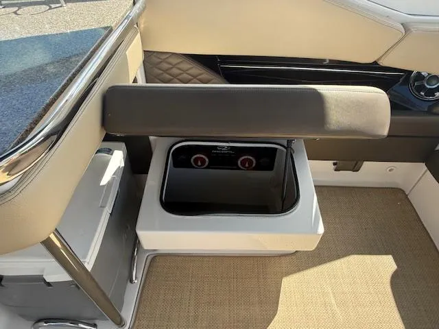 Slide: The Image of 2013 Regal 3200 Bowrider interior with built-in cooler and seating. - 24