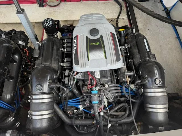 Slide: The Image of Engine of a 2013 Regal 3200 Bowrider boat, showcasing detailed components and wiring. - 31