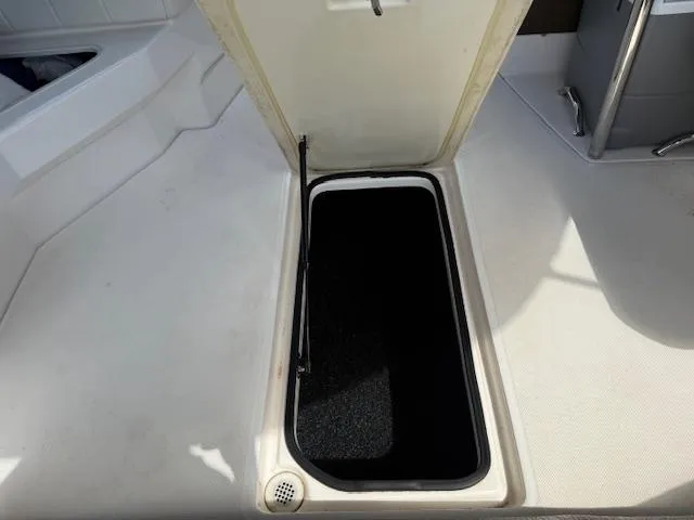 Slide: The Image of Open storage compartment on 2013 Regal 3200 Bowrider boat. - 33