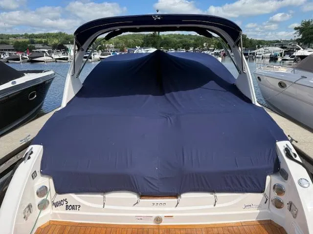 Slide: The Image of 2013 Regal 3200 Bowrider covered at marina, surrounded by other boats. - 37