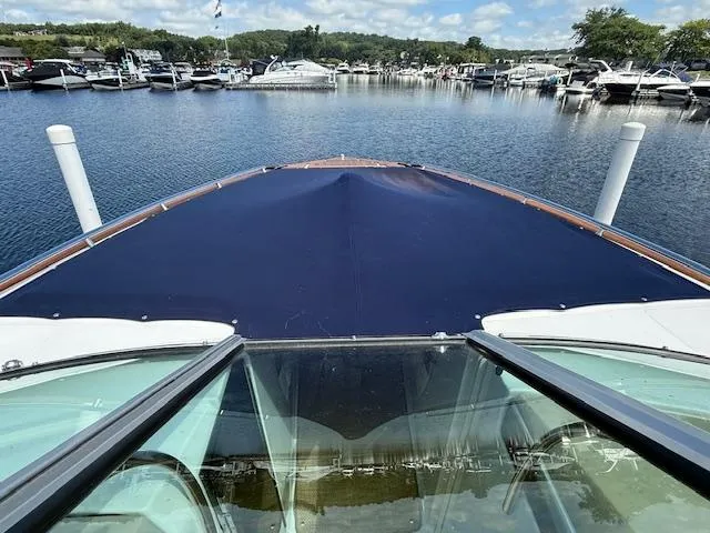 Slide: The Image of 2013 Regal 3200 Bowrider at marina, view from bow, surrounded by boats. - 38